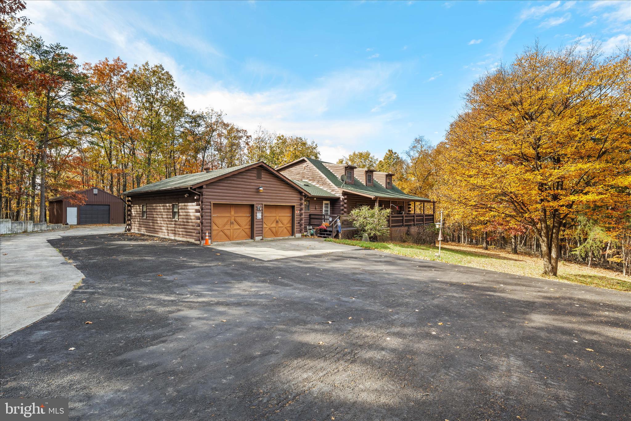 4176 Timber Ridge Road Berkeley Springs, WV 25411 - Photo 4 of 61 a front view of a house with a yard and garage