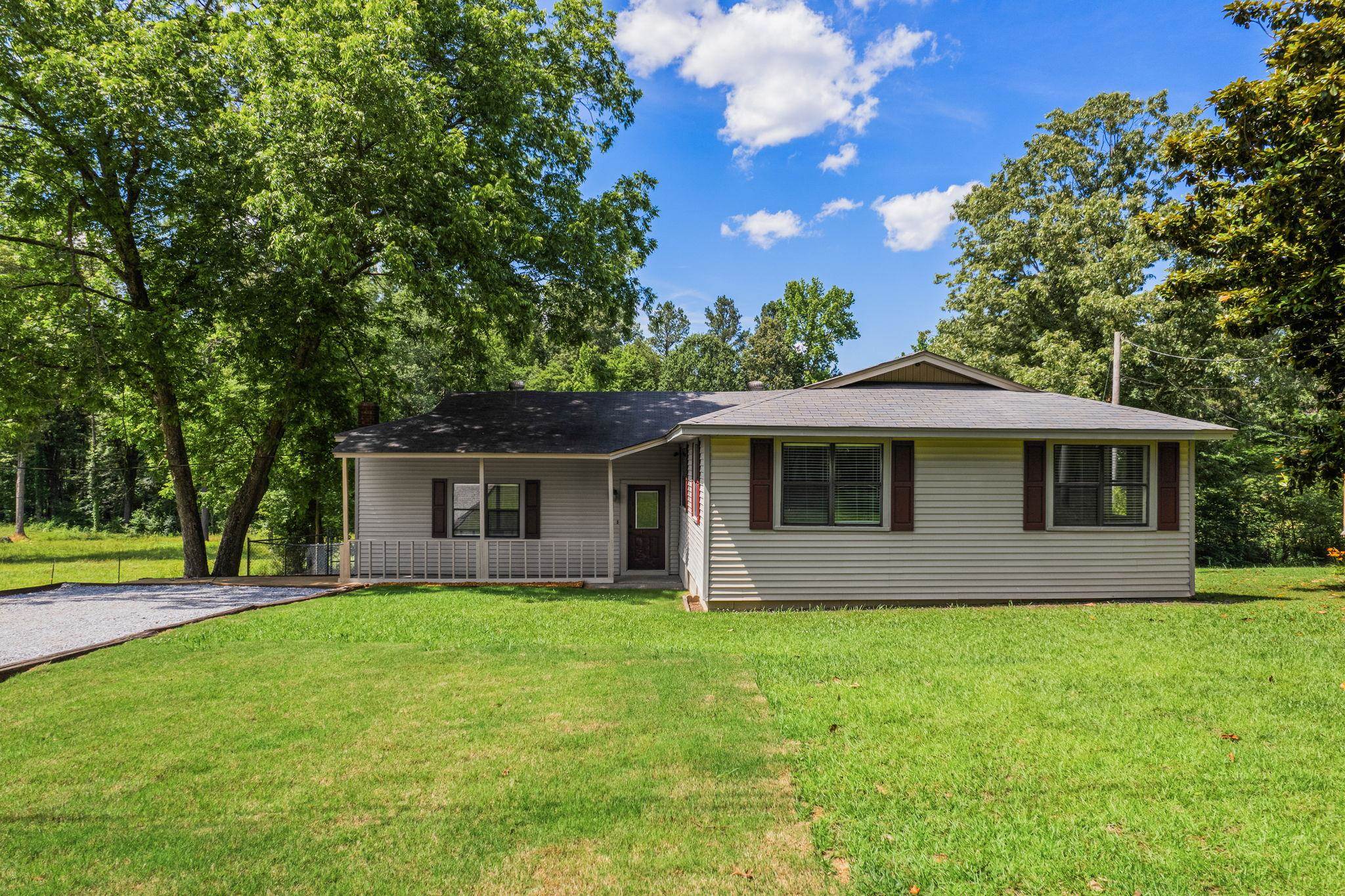 a front view of house with yard and green space