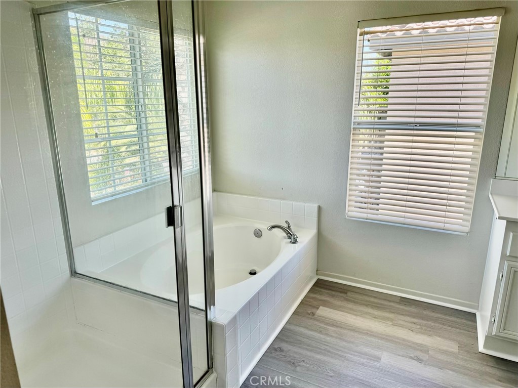 32040 Poppy Way Lake Elsinore, CA 92532 - Photo 12 of 27 a bathroom with a bathtub and a shower