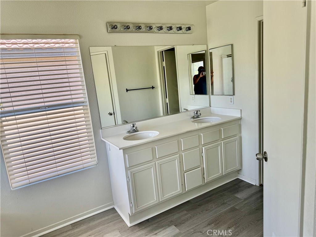 32040 Poppy Way Lake Elsinore, CA 92532 - Photo 13 of 27 a bathroom with a double vanity sink and mirror