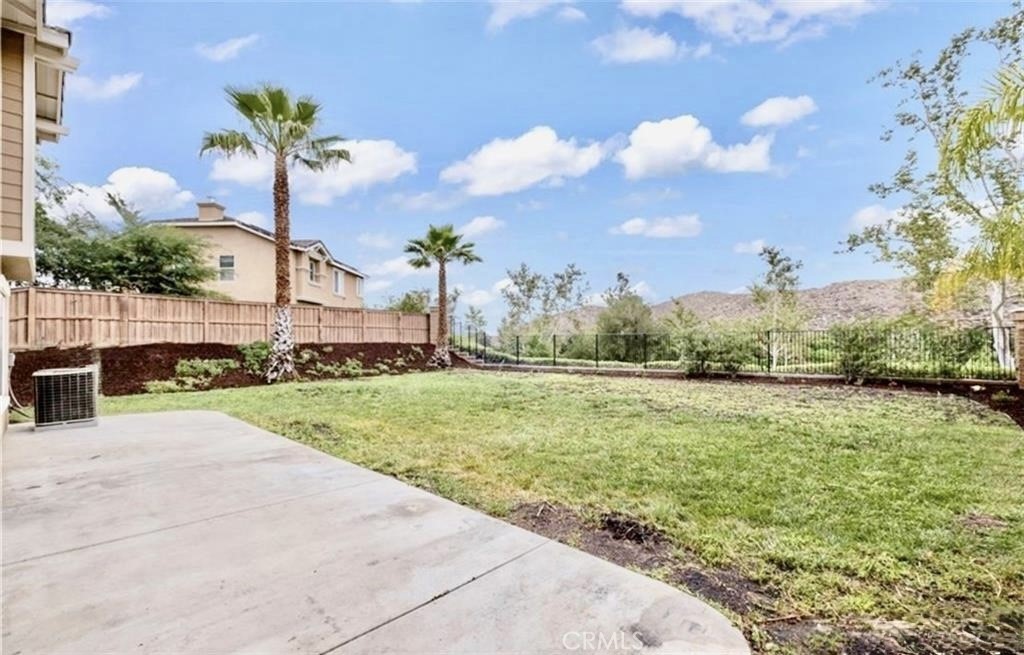 32040 Poppy Way Lake Elsinore, CA 92532 - Photo 22 of 27 a swimming pool with yard and lake view in back