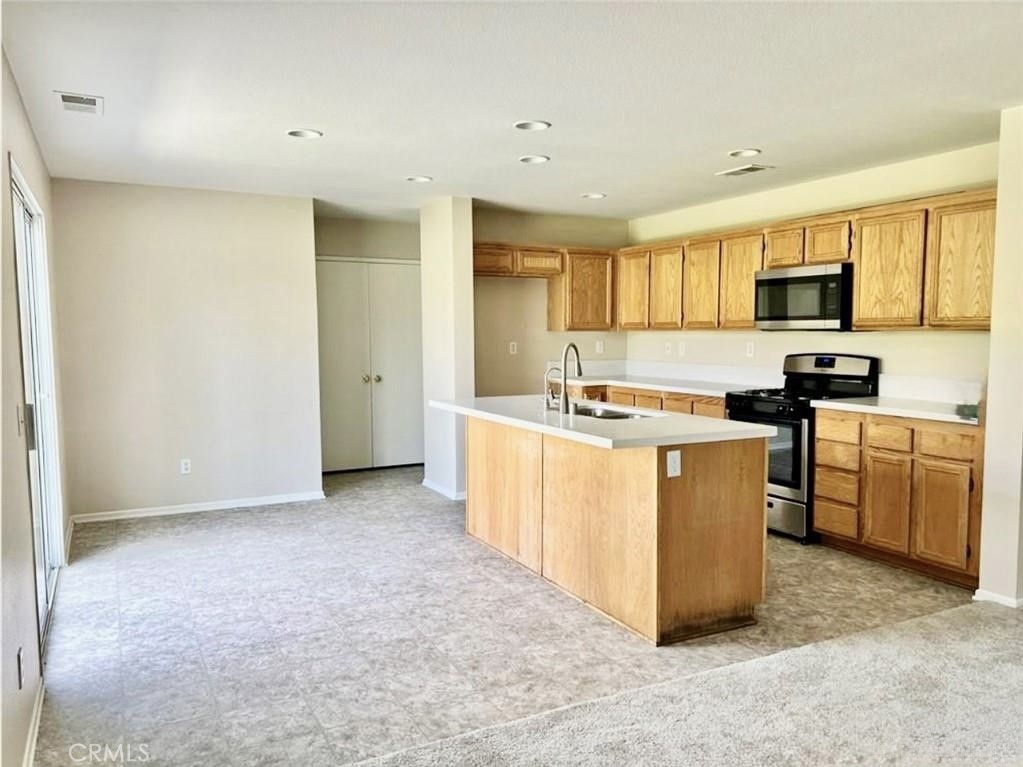 32040 Poppy Way Lake Elsinore, CA 92532 - Photo 8 of 27 a kitchen with sink and cabinets