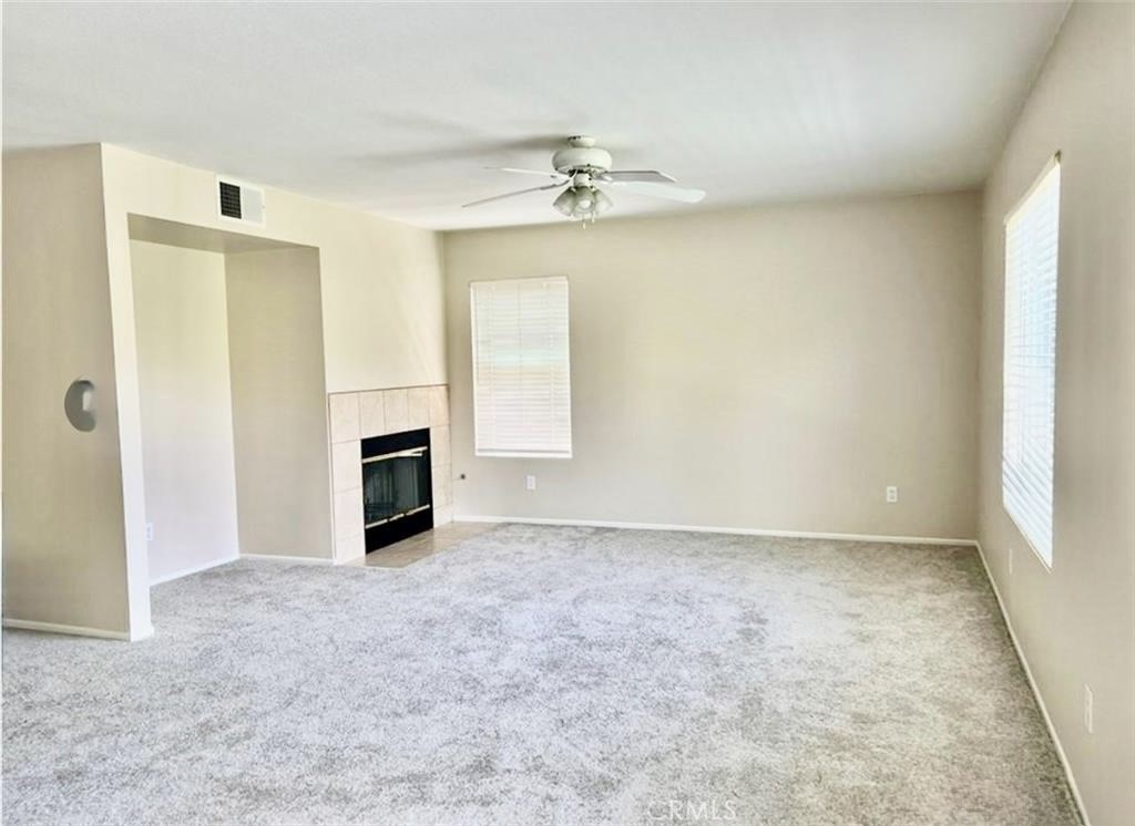 32040 Poppy Way Lake Elsinore, CA 92532 - Photo 10 of 27 an empty room with a fireplace and a window