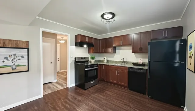 a kitchen with stainless steel appliances granite countertop a refrigerator stove and sink