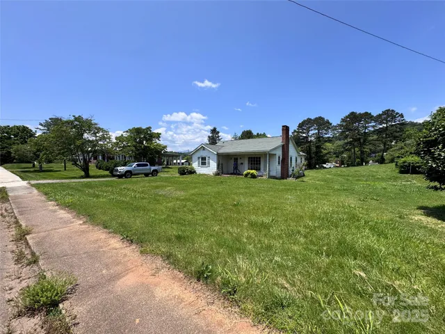 a view of house with yard