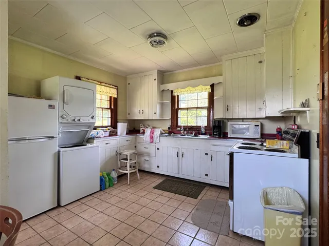 a kitchen that has a lot of cabinets in it and appliances