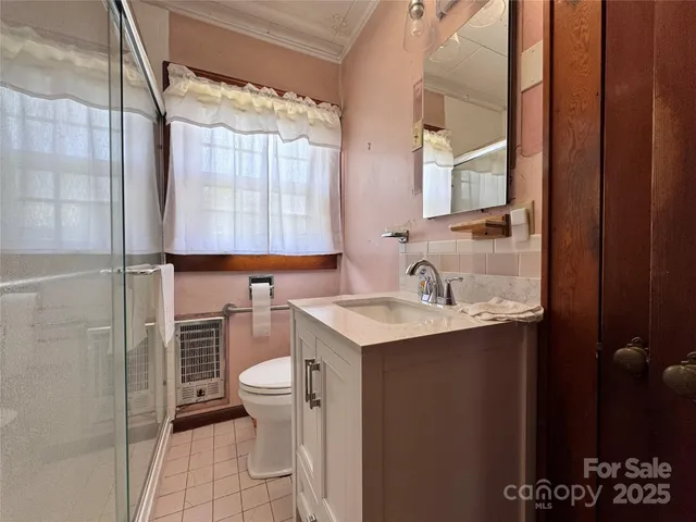 a bathroom with a glass shower door
