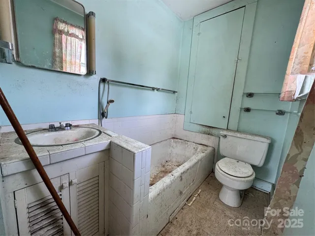 an empty room with window and wooden floor