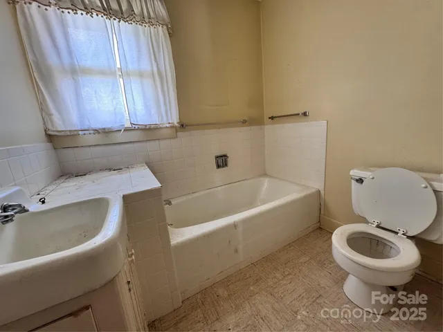 a large room with a couch and wooden floor