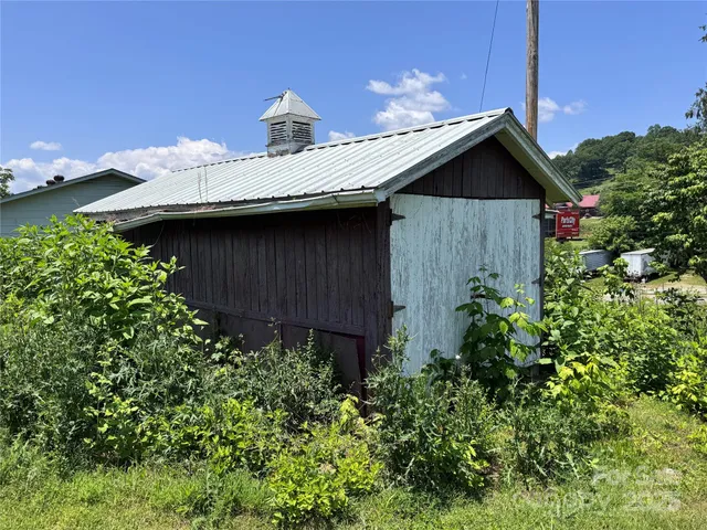 a view of a house with wooden fence
