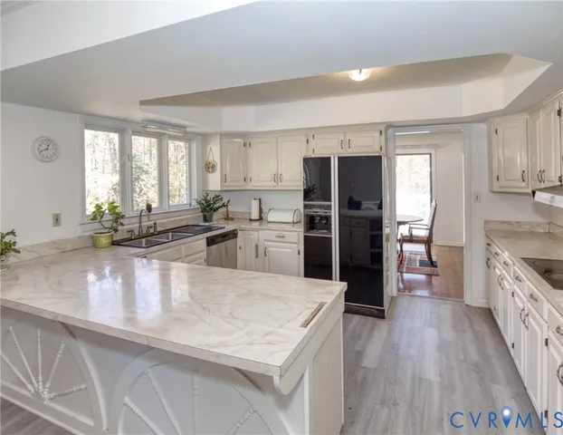 a large kitchen with a large window and stainless steel appliances