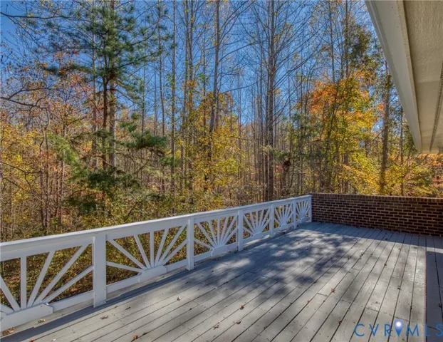 a view of balcony with wooden floor and fence