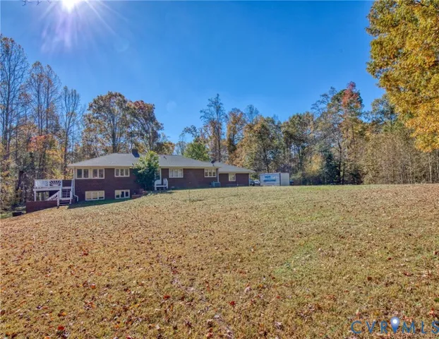 a view of a yard with wooden fence