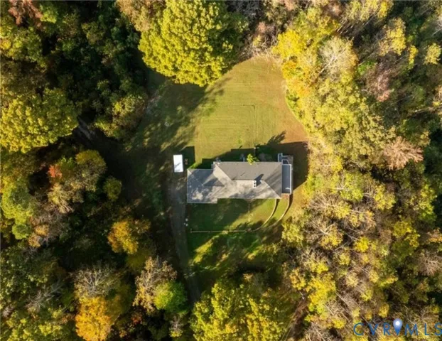 a front view of house with yard and trees