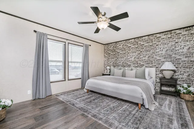 a spacious bedroom with a bed and a chandelier