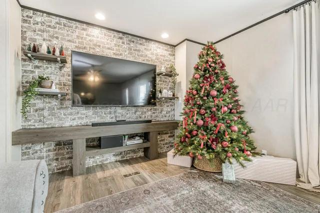 a living room with a flat screen tv and a fireplace