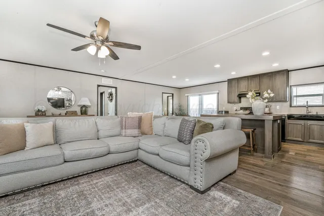 a living room with furniture and kitchen view