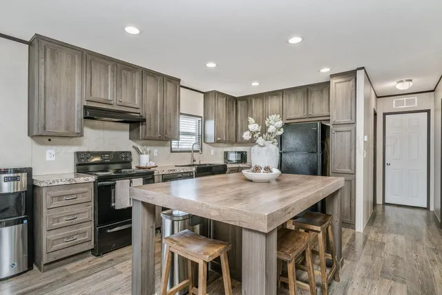 a kitchen with a stove a refrigerator and a stove top oven