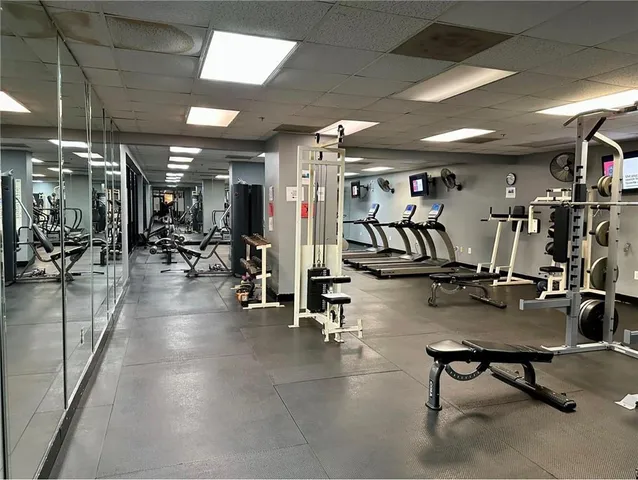 a living room with lots of furniture and lamp