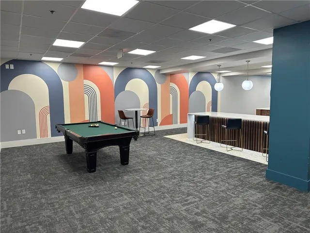 a living room with furniture a rug and a large window