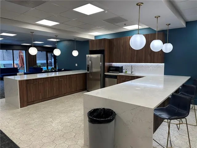 a view of a patio with a table and chairs under an umbrella