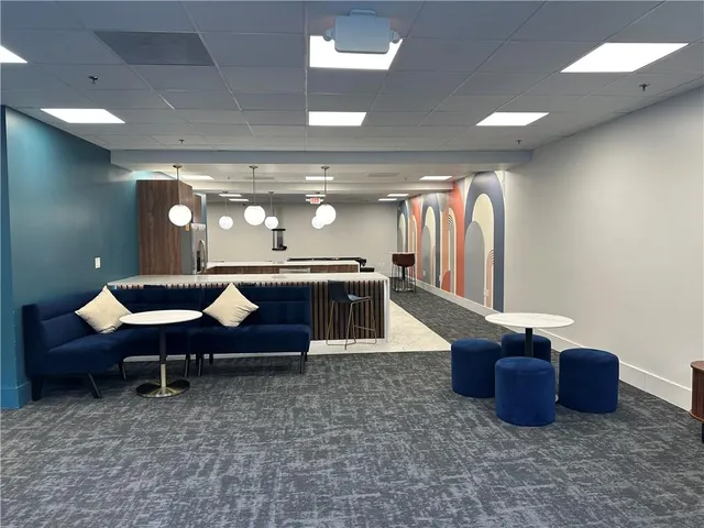 a view of a building with sitting area and furniture