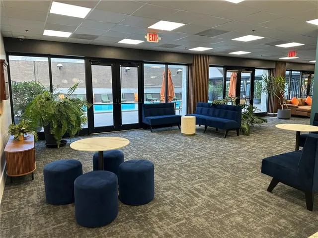 a view of a house with entrance stairs and potted plants