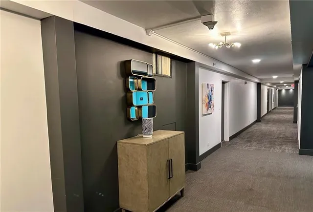 a view of a room with wooden floor and a sink