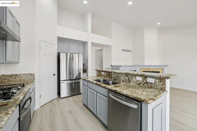 a kitchen with a stove sink and refrigerator
