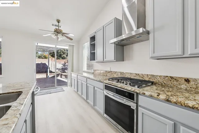 a kitchen with stainless steel appliances granite countertop a stove and a sink