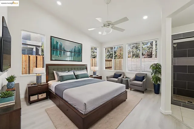 a bedroom with a bed a couch and potted plant with the outer view