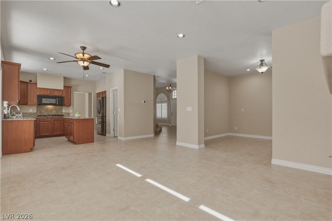 29 Olive Tree Henderson, NV 89074 - Photo 19 of 60 This open concept living space features a modern kitchen and inviting communal areas.