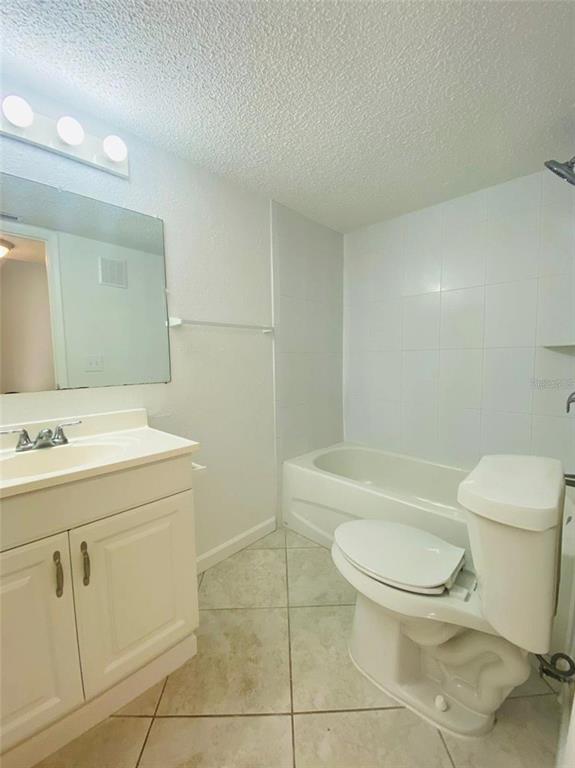 633 North Keene Road, Unit C Clearwater, FL 33755 - Photo 14 of 20 a bathroom with a sink a toilet and a mirror