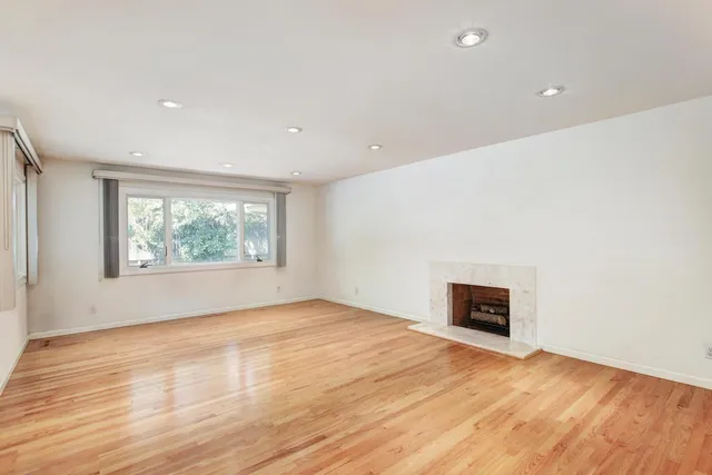 a view of a kitchen with a sink and a refrigerator