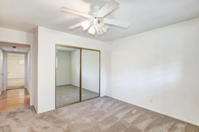 a bathroom with a granite countertop sink and a window