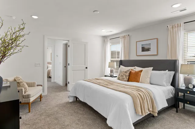 a spacious bedroom with a bed and a window