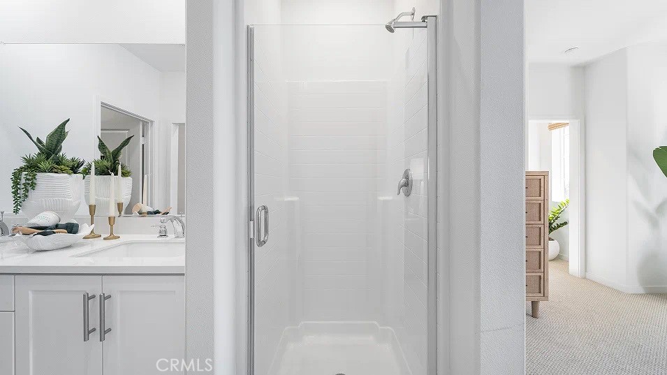 8475 Gabrielino Court Rancho Cucamonga, CA 91730 - Photo 12 of 19 a bathroom with a sink a mirror and a shower