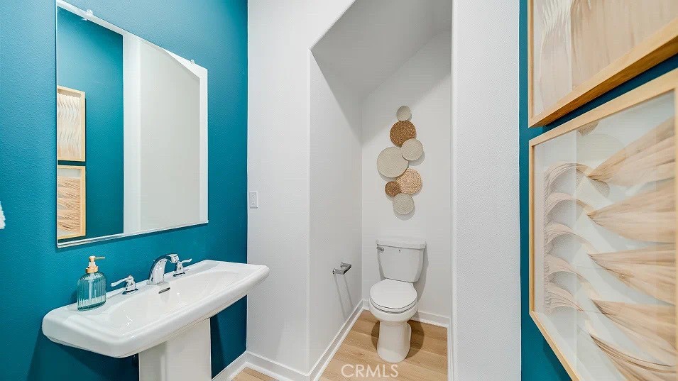 8475 Gabrielino Court Rancho Cucamonga, CA 91730 - Photo 10 of 19 a bathroom with a sink mirror and toilet