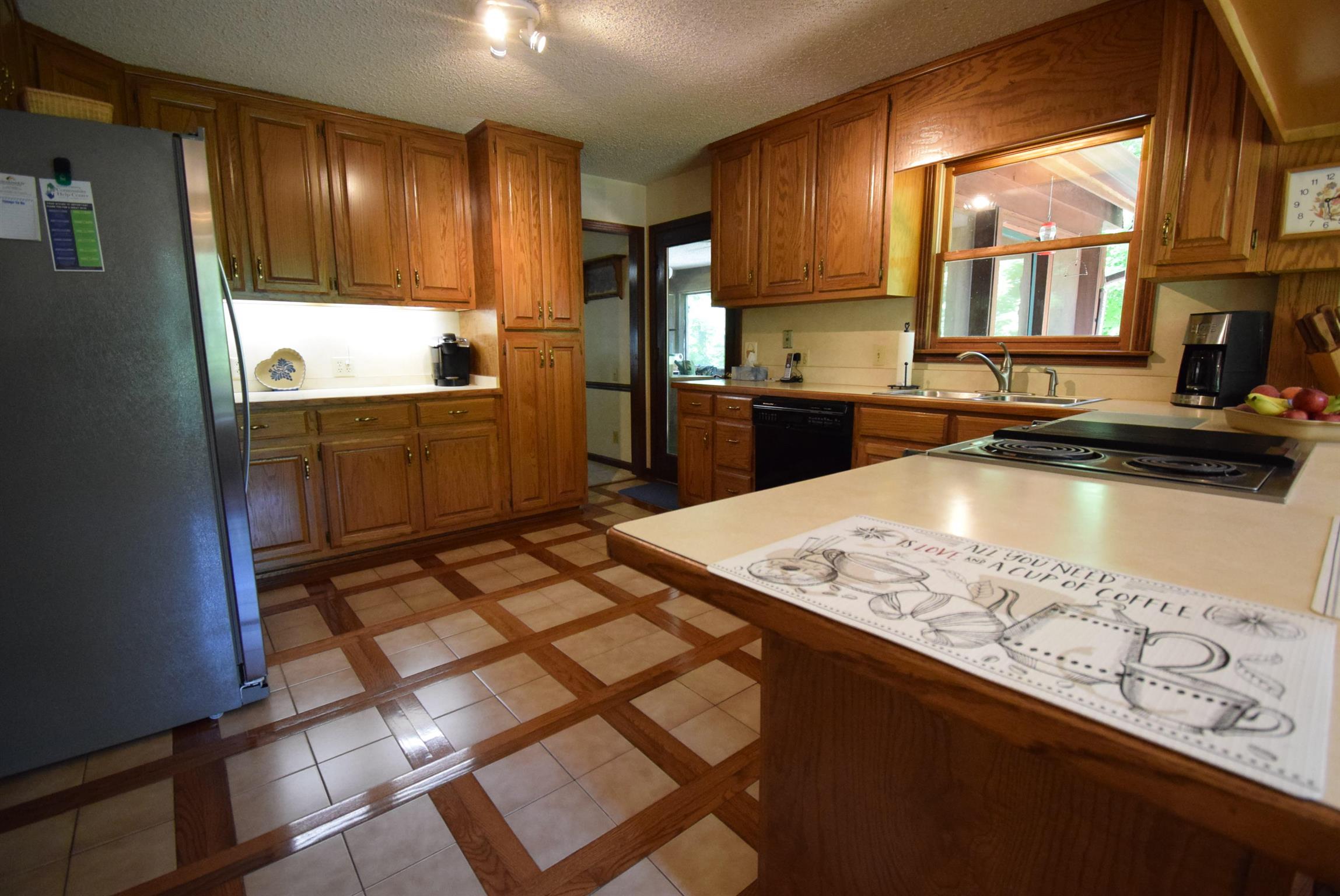 2242 Cedar Grove Road Lebanon, TN 37087 - Photo 5 of 21 a kitchen with kitchen island granite countertop a sink stove and refrigerator