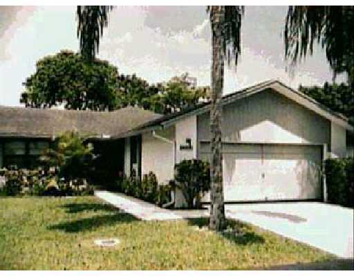 9177 Southwest 22nd Street, Unit F Boca Raton, FL 33428 - Photo 1 of 1 a front view of a house with garden