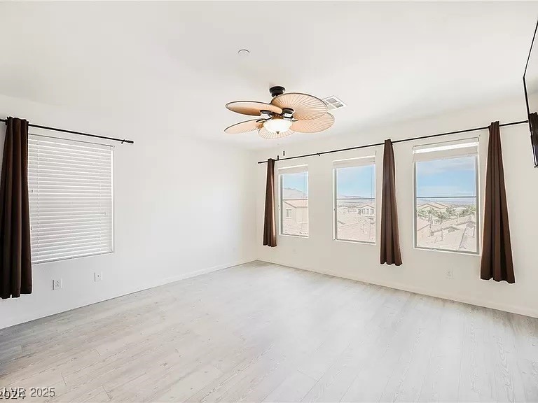 7600 Finishing Touch Court Las Vegas, NV 89149 - Photo 12 of 32 Unfurnished room with light wood-style flooring and a ceiling fan