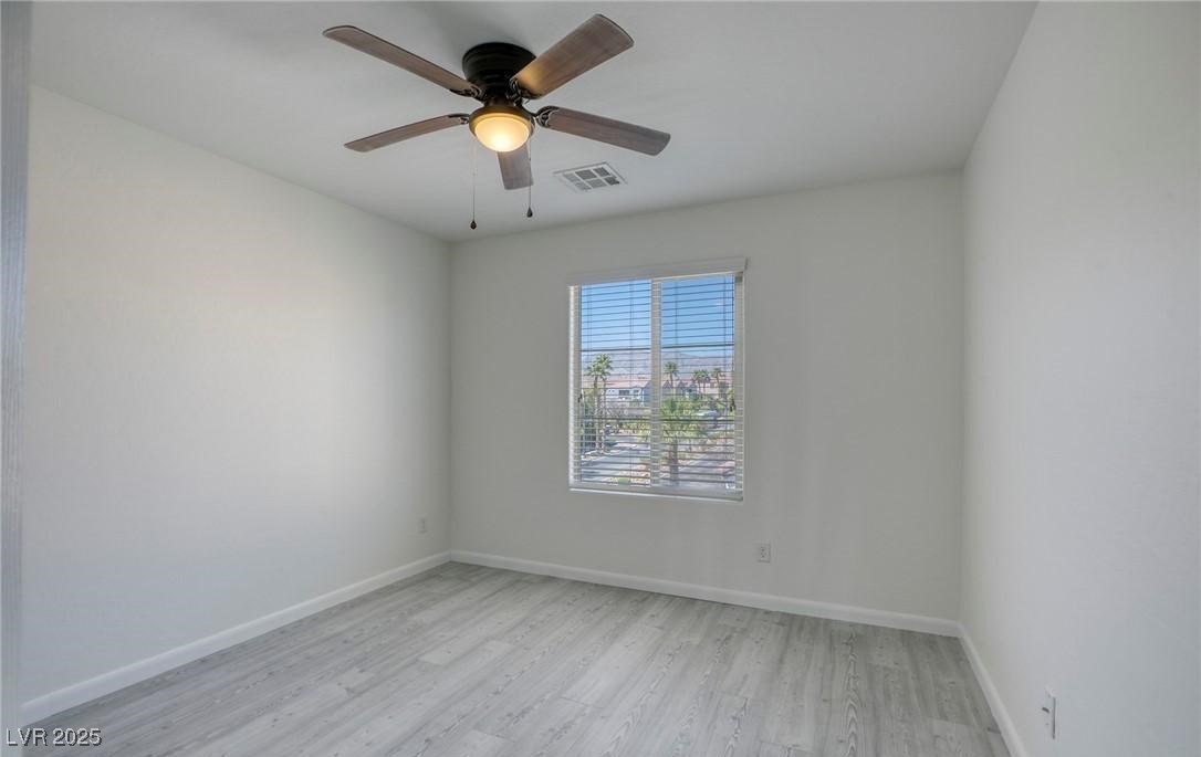 7600 Finishing Touch Court Las Vegas, NV 89149 - Photo 20 of 32 Empty room featuring light wood-type flooring and a ceiling fan