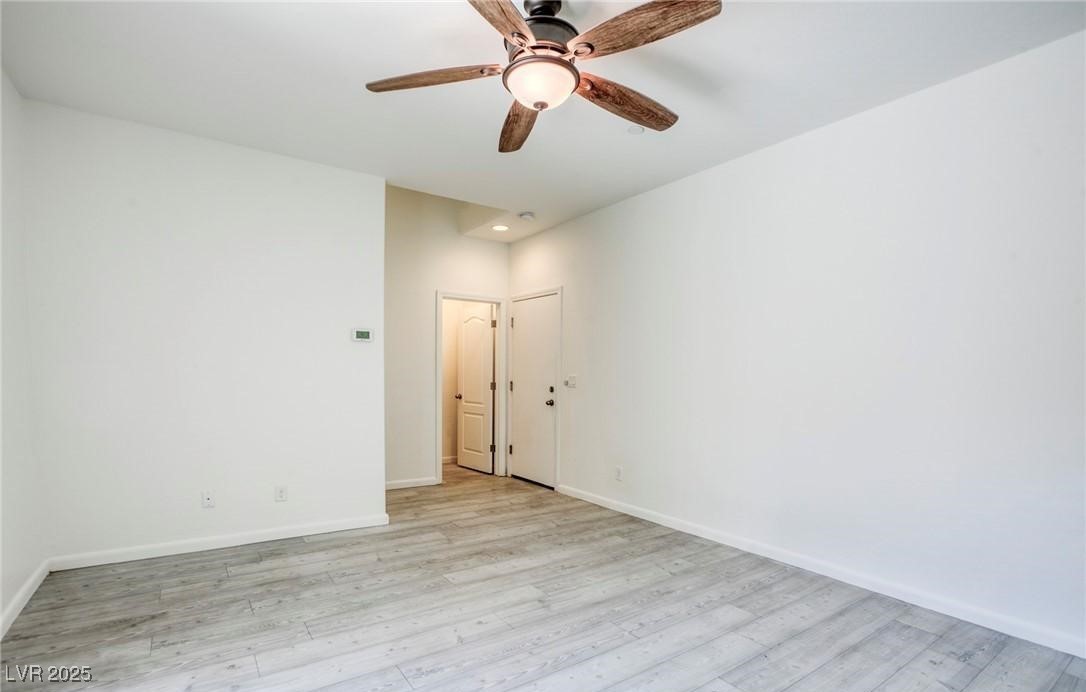 7600 Finishing Touch Court Las Vegas, NV 89149 - Photo 24 of 32 Unfurnished room featuring light wood-type flooring and a ceiling fan