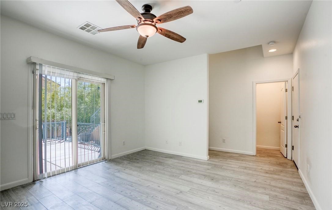 7600 Finishing Touch Court Las Vegas, NV 89149 - Photo 26 of 32 Empty room with light wood finished floors and ceiling fan
