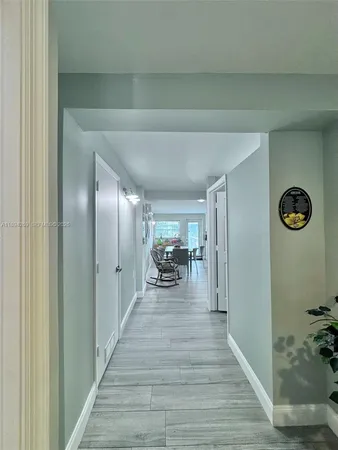 a view of a hallway view with livingroom and furniture