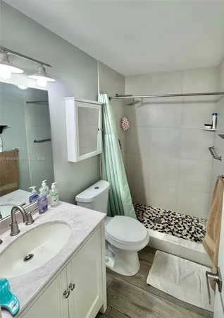 a bathroom with a sink toilet and shower