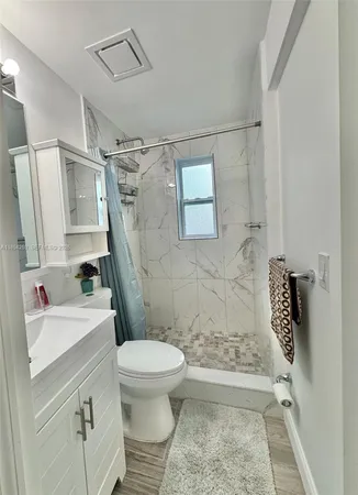 a bathroom with a sink toilet and shower
