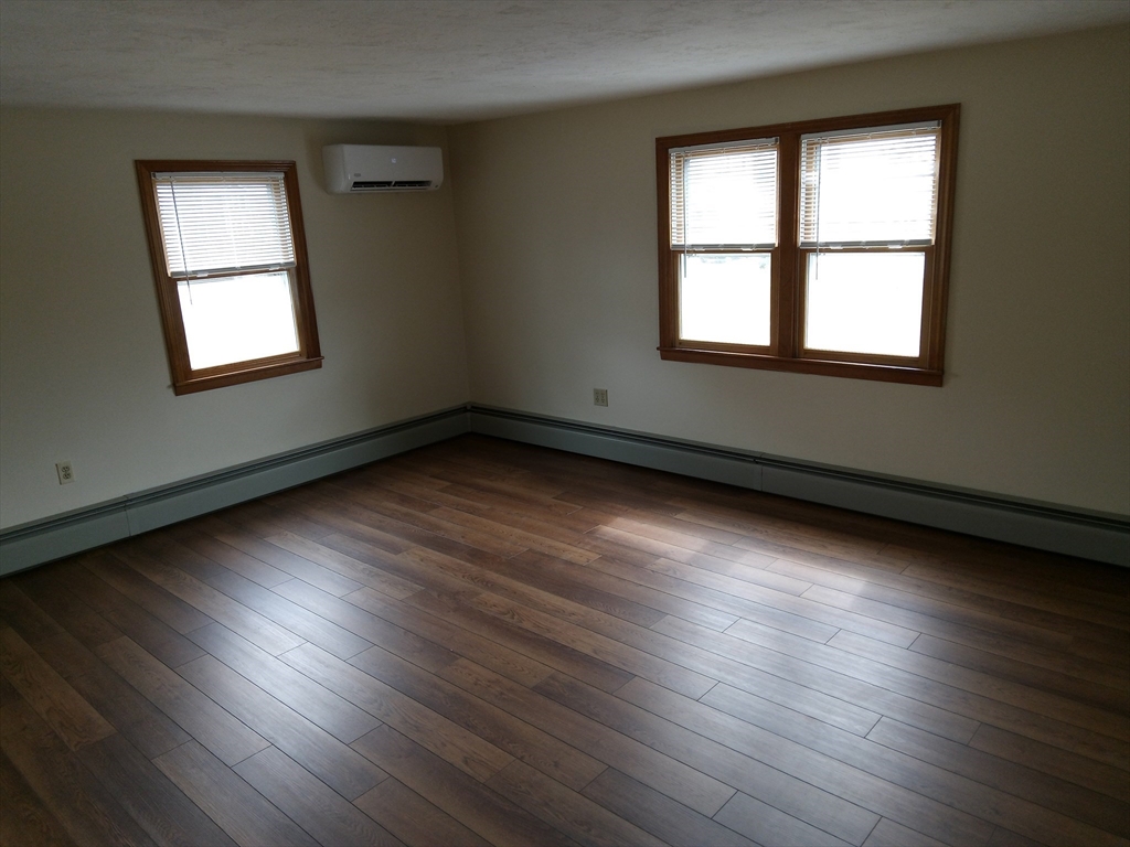 121 King Philip Road Worcester, MA 01606 - Photo 13 of 31 wooden floor in an empty room with a window