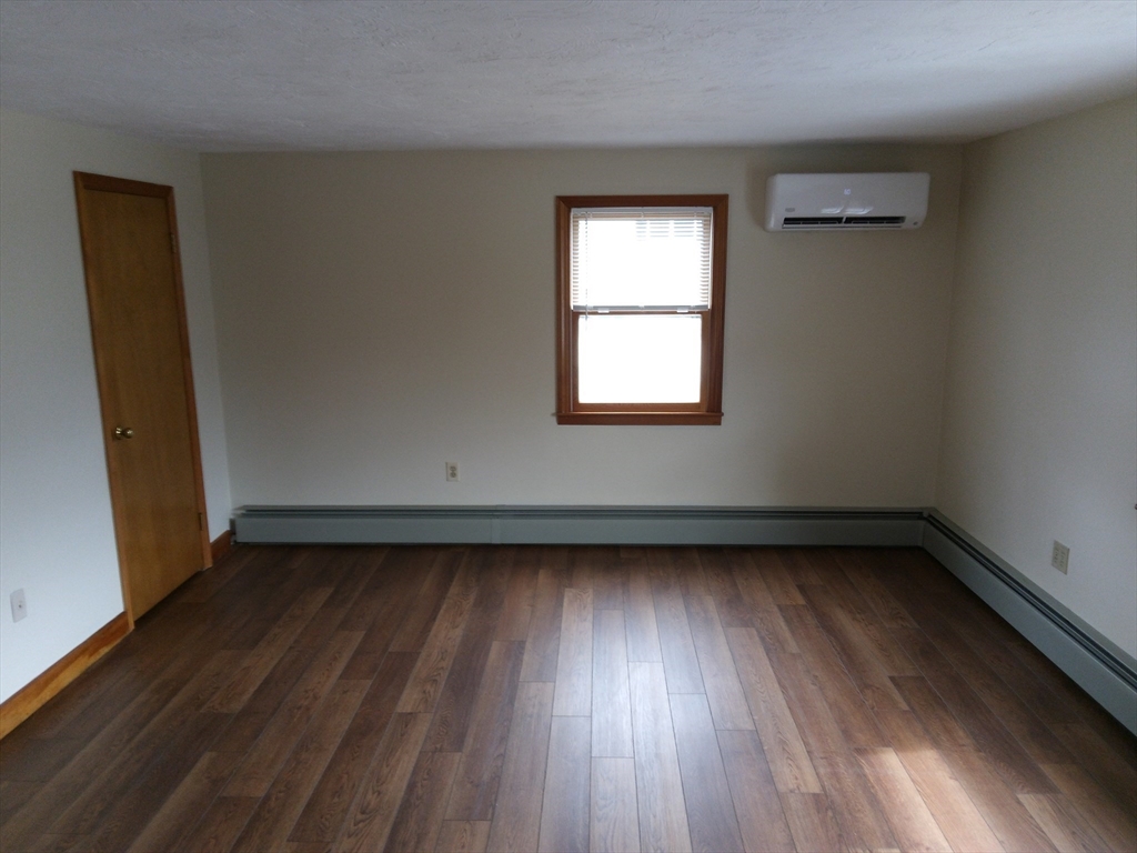 121 King Philip Road Worcester, MA 01606 - Photo 14 of 31 an empty room with wooden floor and windows