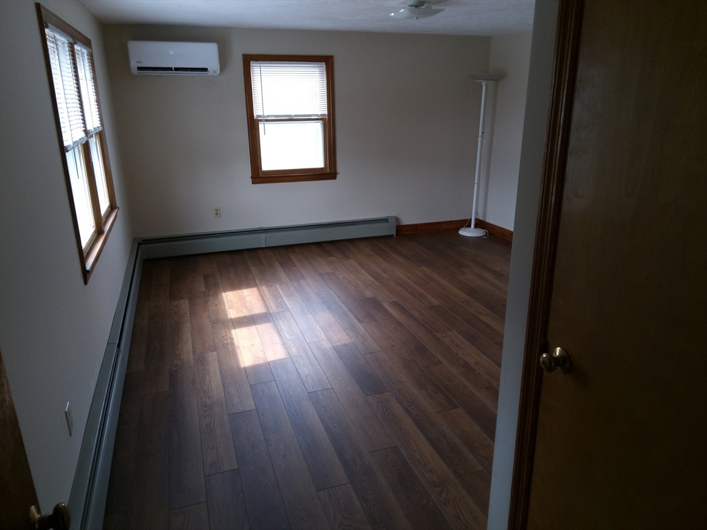 121 King Philip Road Worcester, MA 01606 - Photo 19 of 31 an empty room with wooden floor and windows